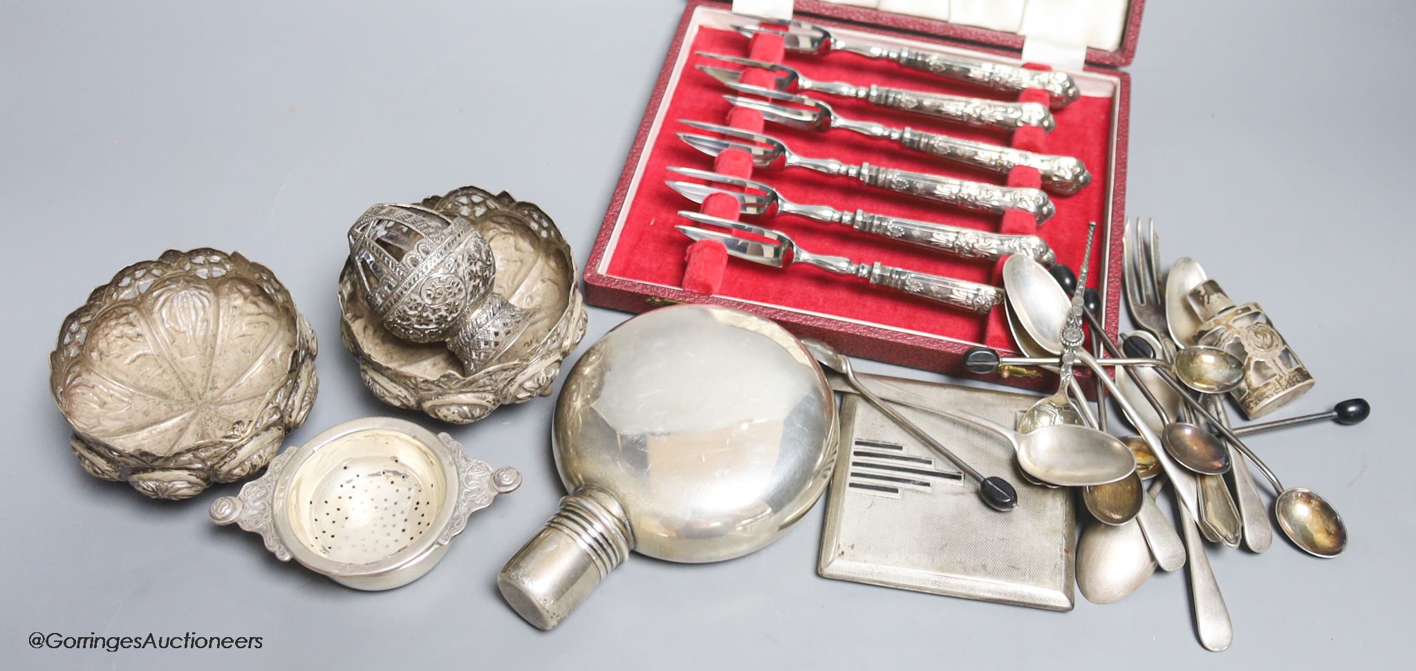 Assorted small silver including a sterling hip flask, cased silver handle tea forks, Art Deco silver cigarette case, teaspoons, tea strainer, overlaid glass scent and three Indian? white metal items, including a pair of